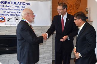 Dr. Jack Ives congratulated by H.E. Simon Tucker